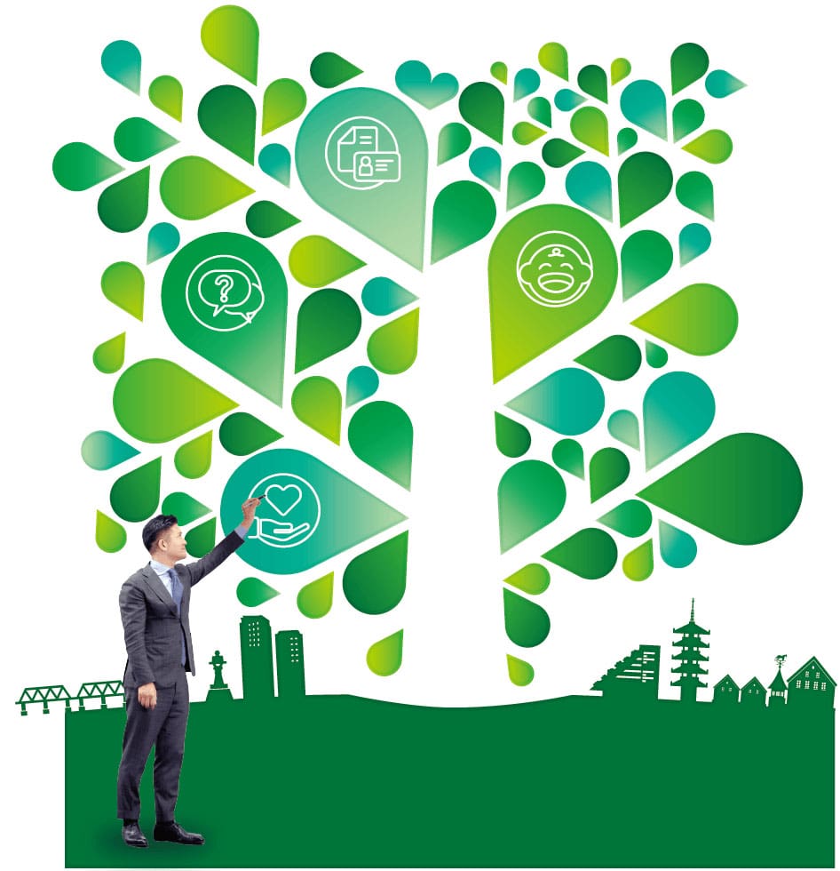 写真:イラストの木を指さしている村越市長